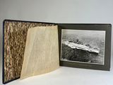 a book opened to show a picture of a boat in the water