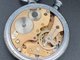a close up of a pocket watch on a table