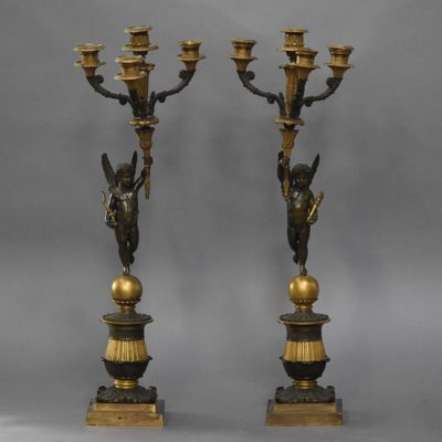 pair of antique bronze candlesticks with cher chers and cher chers