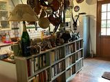 a kitchen with a book shelf and a refrigerator in it
