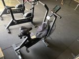 a stationary exercise bike in a gym with a monitor on it