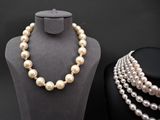 a close up of a mannequin with pearls on display