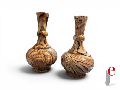 two vases sitting side by side on a white surface