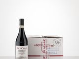 the bottle of wine is next to a box of wine