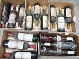several bottles of wine are in a cardboard box on the floor