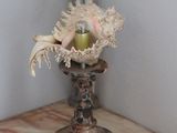 a table with a lamp and a vase with flowers on it