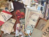 a pile of old books on the floor next to a pile of other books