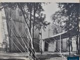 black and white photograph of an old photo of a tent in the woods