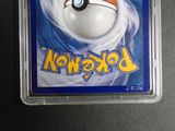 a pokemon card in a plastic case on a table