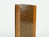 a book with a brown cover sitting on a white surface