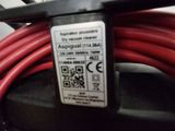 a close up of a red hose connected to a machine