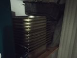a stack of pots and pans on a shelf in a kitchen