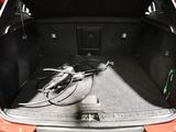 a bike in the trunk of a red car