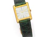 a close up of a watch on a white surface with a white background