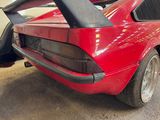 an image of a red sports car parked in a garage
