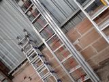 many ladders that are sitting in a room