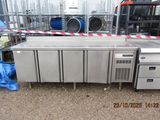 a large stainless steel counter with a bunch of cabinets