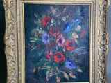 painting of a bouquet of flowers in a gold frame on a gray background