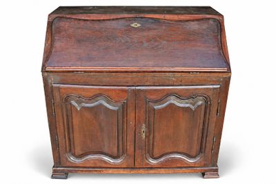 an old wooden cabinet with two doors and a drawer underneath it