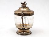 a glass jar with a bird on top of it