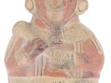 an image of a clay figurine of a man holding a book