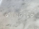 the name of a silver vase is etched into the marble