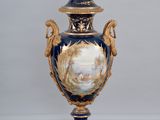 a vase on a pedestal on a checkered floor
