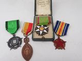 an assortment of medals including a star, medal, and other items