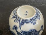 a blue and white vase sitting on a table