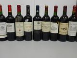 several bottles of wine are lined up on a table