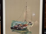 painting of a sailboat in a frame on a table