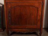 a wooden cabinet with a mirror on top of it
