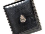 a small black case with a silver emblem on it