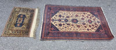 two oriental rugs on the ground next to each other