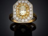 a yellow and white diamond ring set in 18k gold