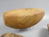 a loaf of bread sitting on a stand next to some rocks