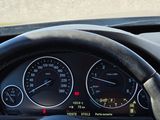 a steering wheel and dashboard of a car on the street