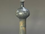 a gray vase that is sitting on a table
