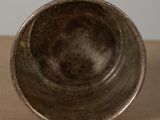 a close up of a metal bowl on a table