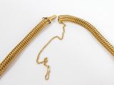 a gold necklace with a chain that is attached to it