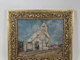 painting of a church in a gold frame on a white wall