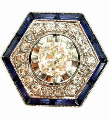 an image of a diamond and sapphire broochle on a white background