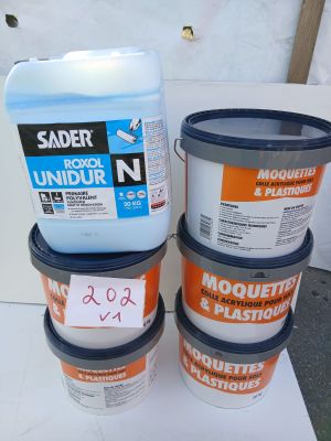 three buckets of paint sitting on top of a table next to each other