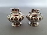 pair of silverplated salt and pepper shakers on a table
