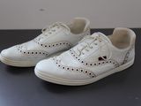 a pair of white shoes that are on a table