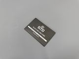 a black and white picture of a business card on a gray surface