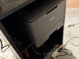 a printer sitting on top of a desk next to a keyboard