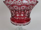 a small red glass bowl on a clear base