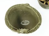 a metal bowl and a metal bowl on a white table