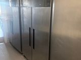 stainless steel refrigerators are lined up in a row in a commercial kitchen